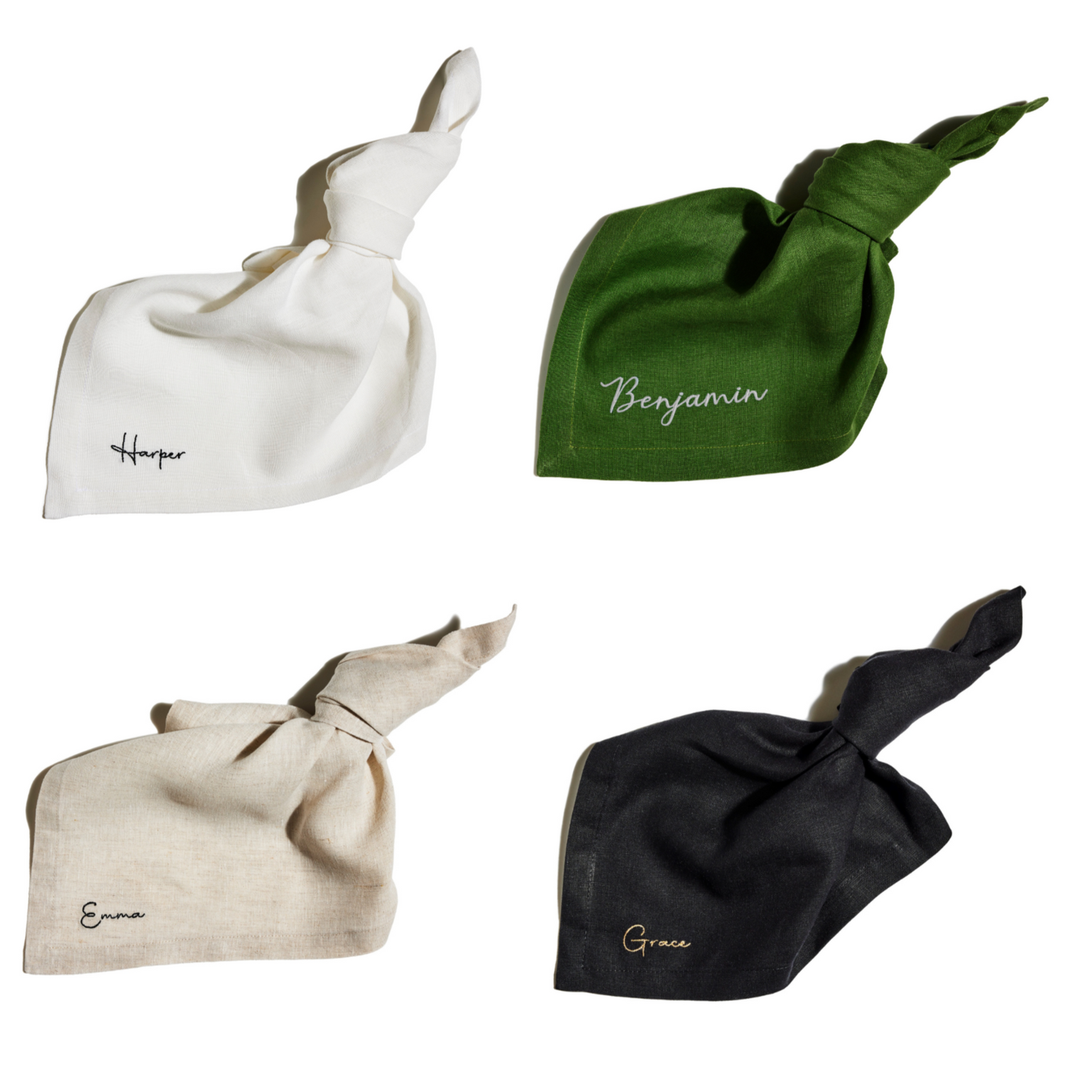 Four embroidered linen napkins in white, green, natural, and black, personalised with the names Harper, Benjamin, Emma, and Grace.