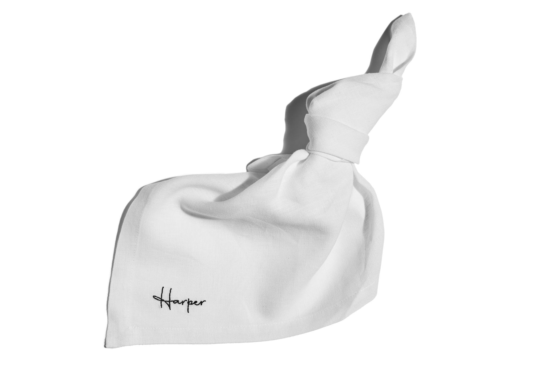 Embroidered white linen napkin with guest name in black thread