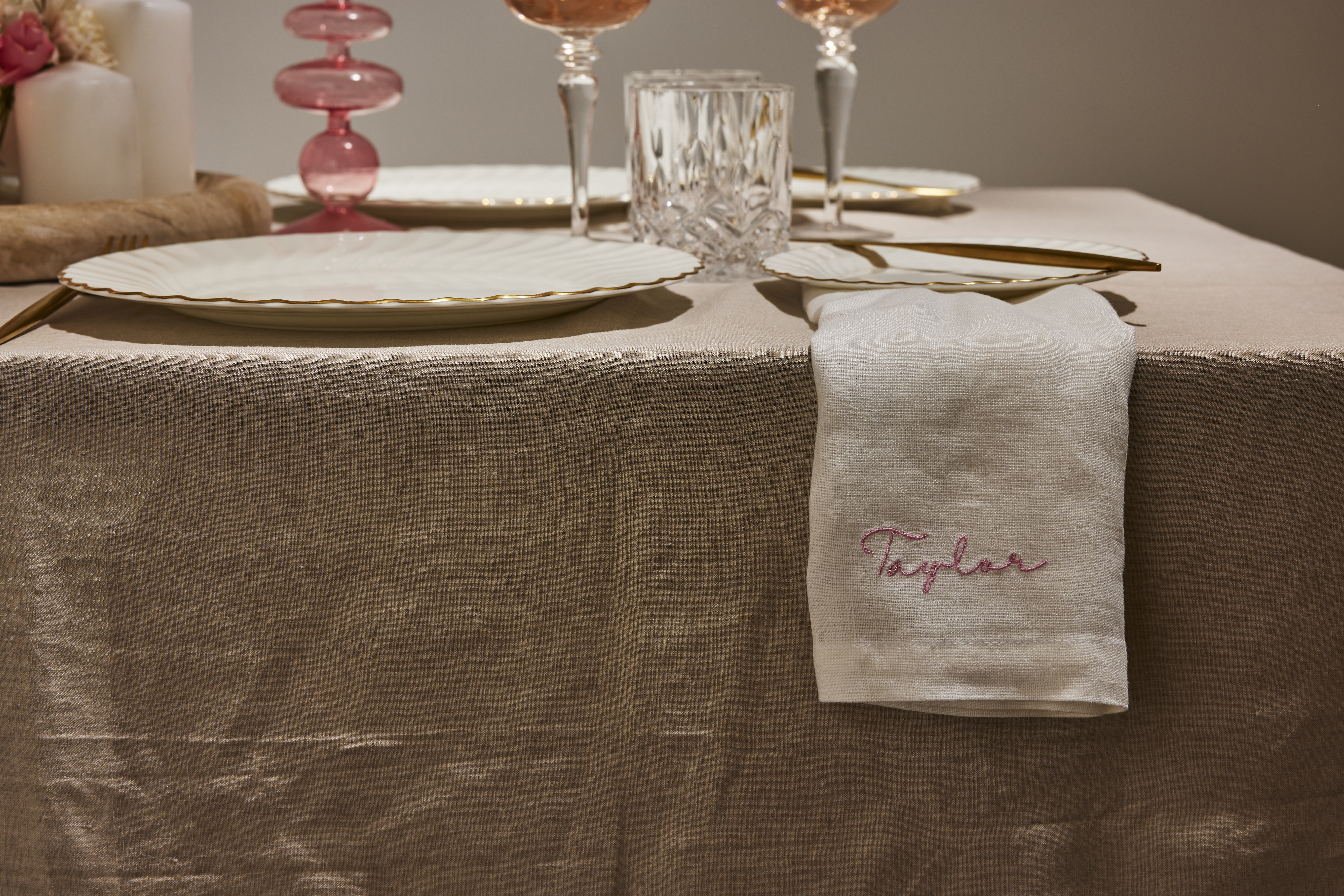 Ivory Napkin with blush writing overhanding a table